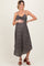 woman wearing a black floral maternity dress and holding her baby bump