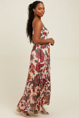 woman wearing a floral print maxi dress with spaghetti straps and a flowing silhouette