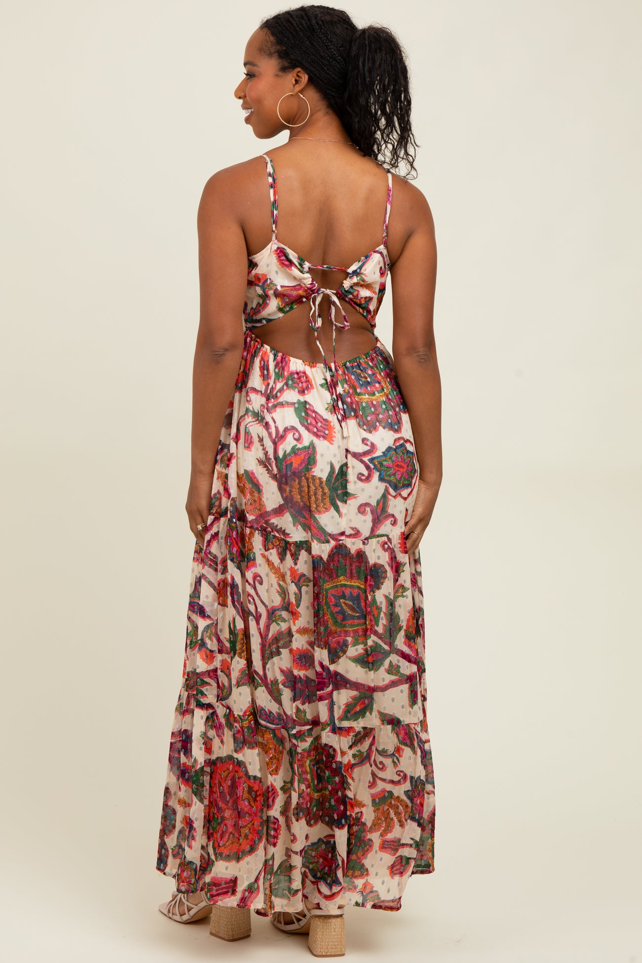 woman wearing a floral printed back tie crop top and matching long maxi skirt