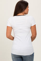woman wearing a white short sleeve maternity top, viewed from the back, paired with blue jeans