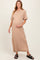 woman wearing a beige short sleeve maternity maxi dress and holding her baby bump