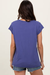woman wearing a purple short sleeve t-shirt and denim shorts, viewed from the back