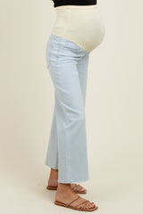 woman wearing light blue maternity jeans with a supportive belly band, showcasing her baby bump
