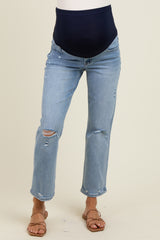 woman wearing light blue distressed maternity jeans with a navy over-the-bump waistband