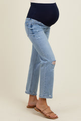 woman wearing light blue maternity jeans with a dark blue over-the-bump panel and distressed details, showing her baby bump