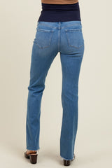 woman wearing blue maternity jeans viewed from the back with a flared leg and dark waistband