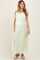 woman wearing a light green maternity maxi dress with a tie waist and adjustable straps, showing a baby bump