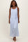 woman wearing a light blue sleeveless maxi dress with a tie waist and gathered neckline