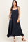 woman wearing a dark navy maxi dress with spaghetti straps and ruffle hem, featuring pockets and a flowy silhouette