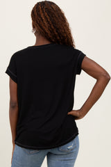 woman wearing a black short sleeve t-shirt, viewed from the back, paired with light blue jeans