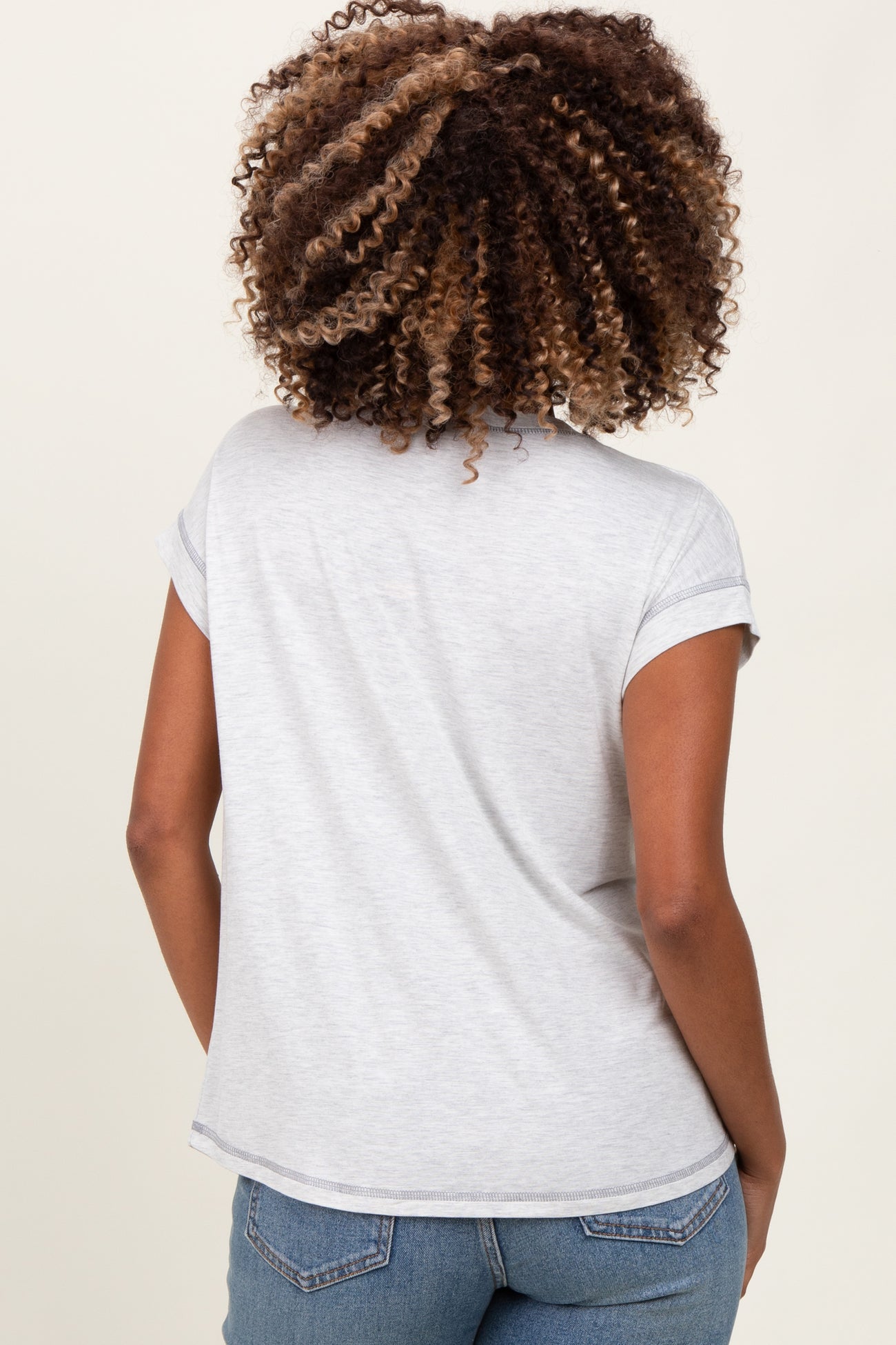 woman wearing a grey short sleeve maternity top, viewed from the back