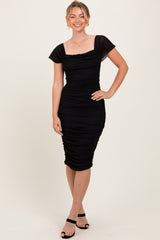 woman wearing a black fitted ruched midi dress with cap sleeves and a square neckline