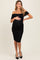 woman wearing a black off-shoulder ruched maternity dress and holding her baby bump