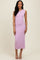 woman wearing a light pink sleeveless ribbed midi dress with a fitted silhouette and a slight flare at the hem