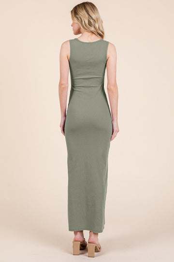 woman wearing a form-fitting olive green maxi dress, shown from the back, with a sleek silhouette and no sleeves