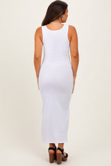 woman wearing a white ribbed maternity maxi dress, view from the back, no visible baby bump
