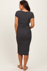 woman wearing a black and white striped maternity midi dress with short sleeves and a side slit, showing her baby bump