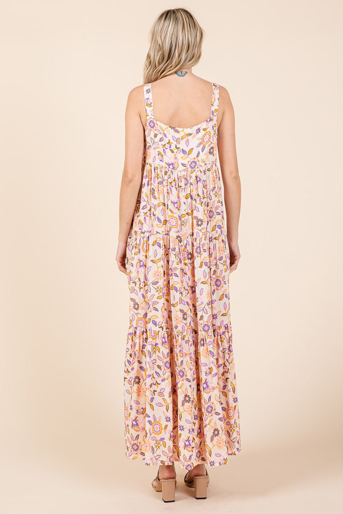 woman wearing a floral maxi dress with tiered detailing and adjustable straps, view of the back