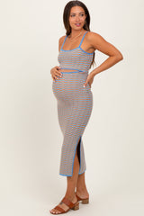 woman wearing a multi-colored striped maternity dress with side slits and a visible baby bump