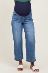 woman wearing light blue maternity wide-leg jeans with a navy blue over-the-belly waistband