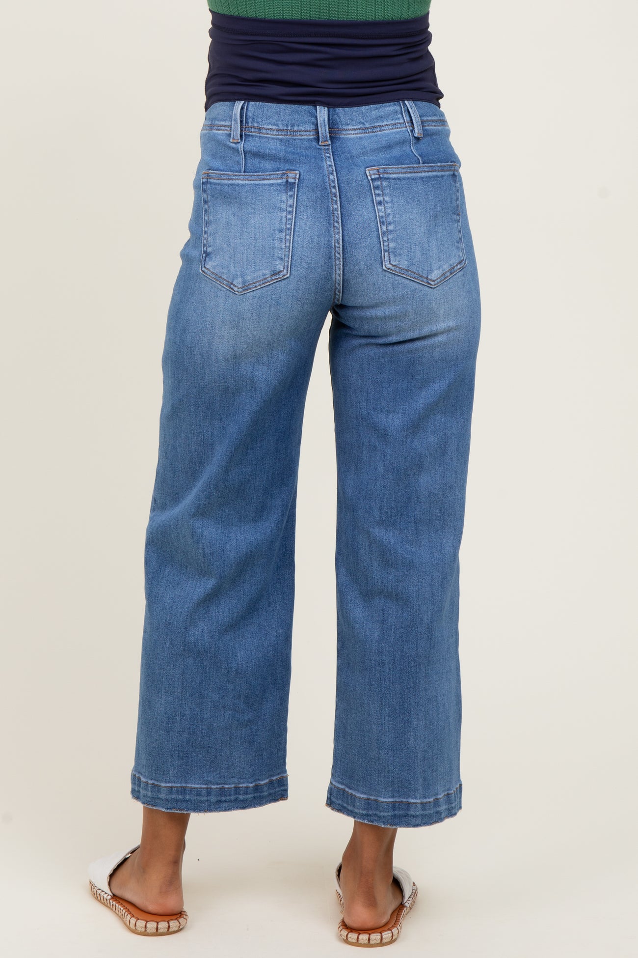 woman wearing light blue maternity wide-leg jeans, seen from the back