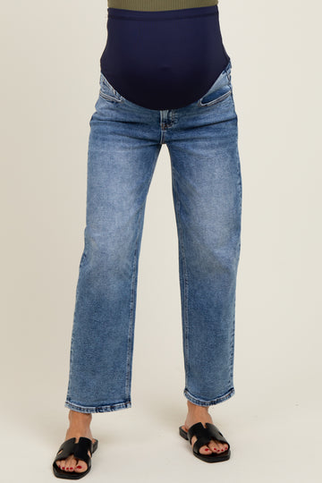 woman wearing maternity light blue straight leg jeans with a dark blue belly band
