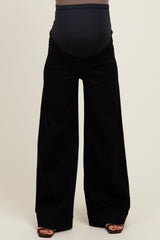 woman wearing black wide-leg maternity pants with a supportive belly band