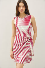 woman wearing a red and white striped sleeveless dress with a knot detail at the waist
