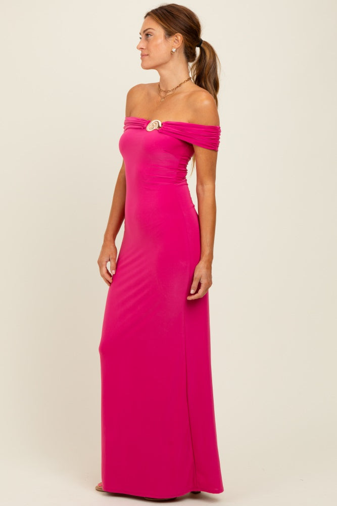 woman wearing a hot pink off-the-shoulder long dress with a decorative brooch on the side