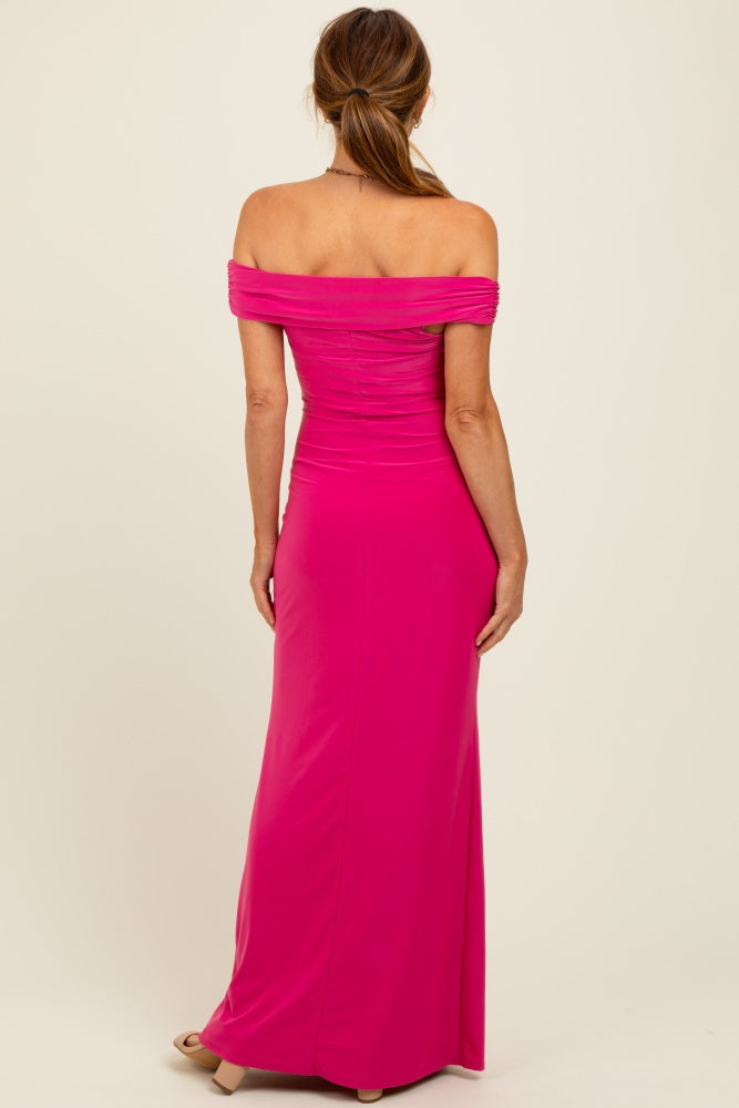 woman wearing a fuchsia off-shoulder maxi dress with gathered detailing at the bodice and fitted silhouette