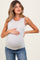 woman wearing a light gray maternity tank top with a ribbed texture and pink trim, holding her baby bump