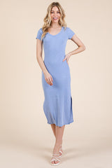 woman wearing a light blue short sleeve midi dress with a side slit and a scoop neckline