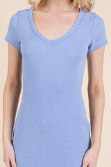 woman wearing a light blue short sleeve ribbed dress with a v-neckline