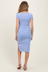 woman wearing a light blue maternity midi dress with a bodycon fit and a side slit, shown from the back
