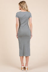 woman wearing a grey fitted midi dress with short sleeves, seen from the back