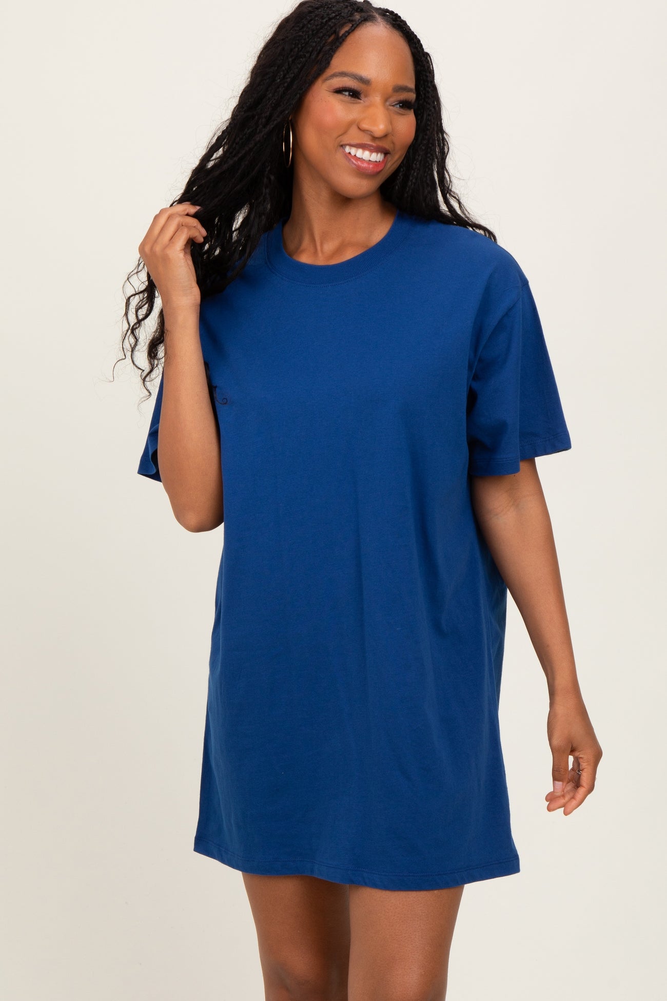 woman wearing a blue oversized t-shirt dress with short sleeves and a relaxed fit