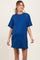woman wearing a blue short sleeve maternity t-shirt dress with a visible baby bump
