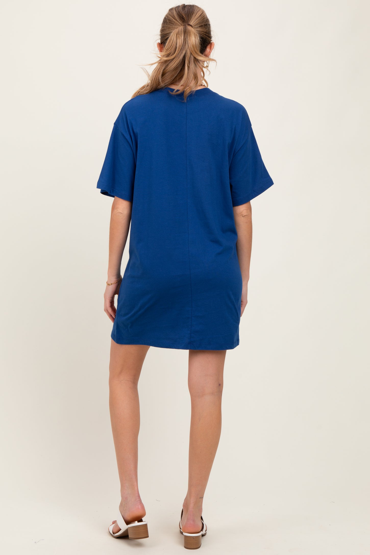 woman wearing a blue short sleeve maternity dress, shown from the back