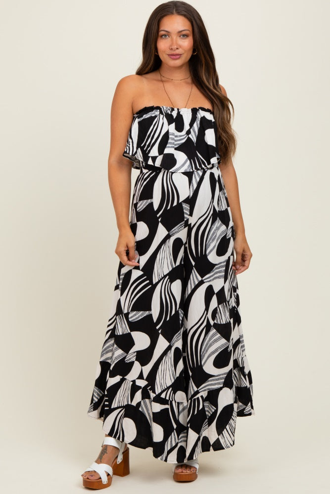 woman wearing a black and white patterned strapless maxi dress, showcasing a flowing style suitable for maternity wear