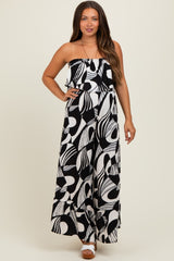 woman wearing a black and white patterned maternity maxi dress with a ruffled neckline and wide leg style