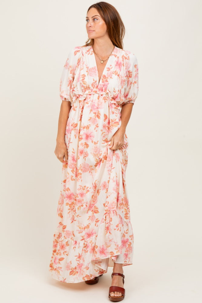 woman wearing a floral print maxi dress with puff sleeves and a deep v-neckline