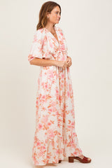 woman wearing a floral maxi dress with puff sleeves and ruffles, styled with red platform heels