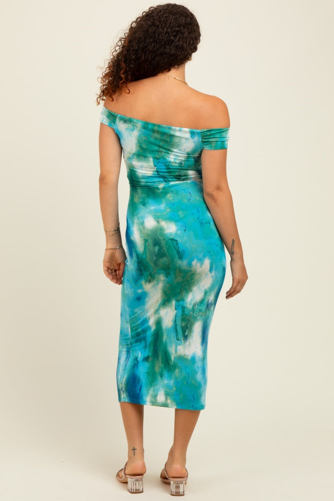 woman wearing an off-the-shoulder blue and green tie-dye maternity dress with a fitted silhouette