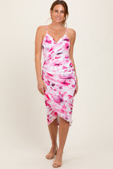 woman wearing a pink and white floral print spaghetti strap dress with a gathered detail at the waist
