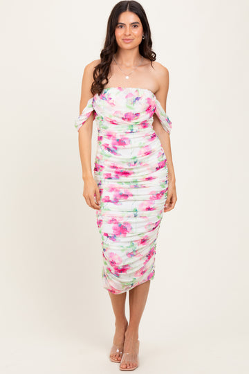 woman wearing a strapless floral midi dress with ruching and off-the-shoulder ties