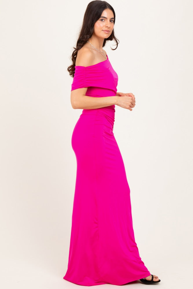 woman wearing a hot pink off-the-shoulder maxi dress with fitted style and ruching details