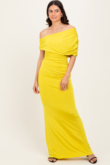 woman wearing a bright yellow off-shoulder maxi dress with gathered detailing and a fitted silhouette