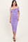 woman wearing a lavender off-the-shoulder midi dress with ruching details and a fitted silhouette