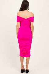 woman wearing a pink off-the-shoulder bodycon dress with ruching detail and a fitted midi length, shown from the back