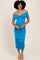 woman wearing a bright blue off-the-shoulder fitted dress with ruched details, standing against a neutral background